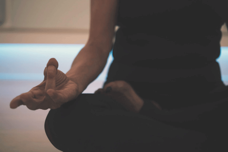 close up of the hand of someone meditating